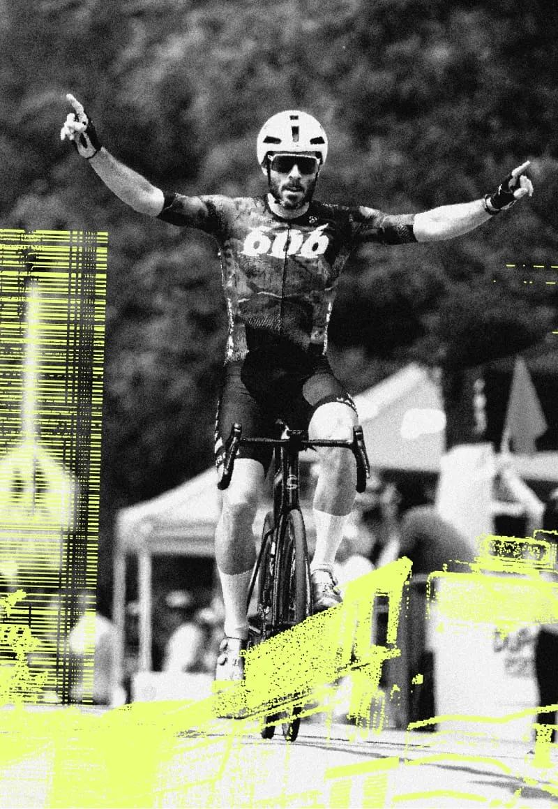 An elite Illinois Cup rider celebrates a win with both arms raised.